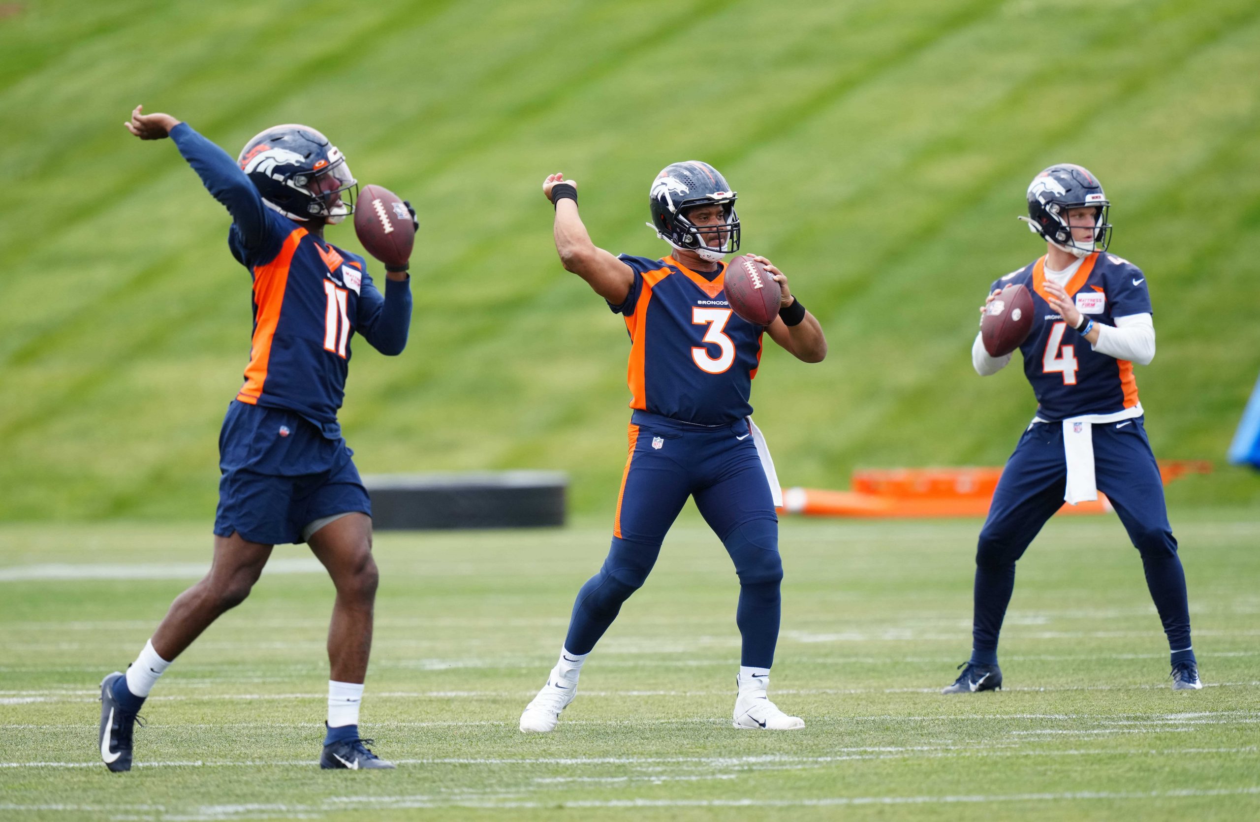 Denver Broncos quarterback Josh Johnson and quarterback Russel Wilson and quarterback Brett Rypien during OTA workouts