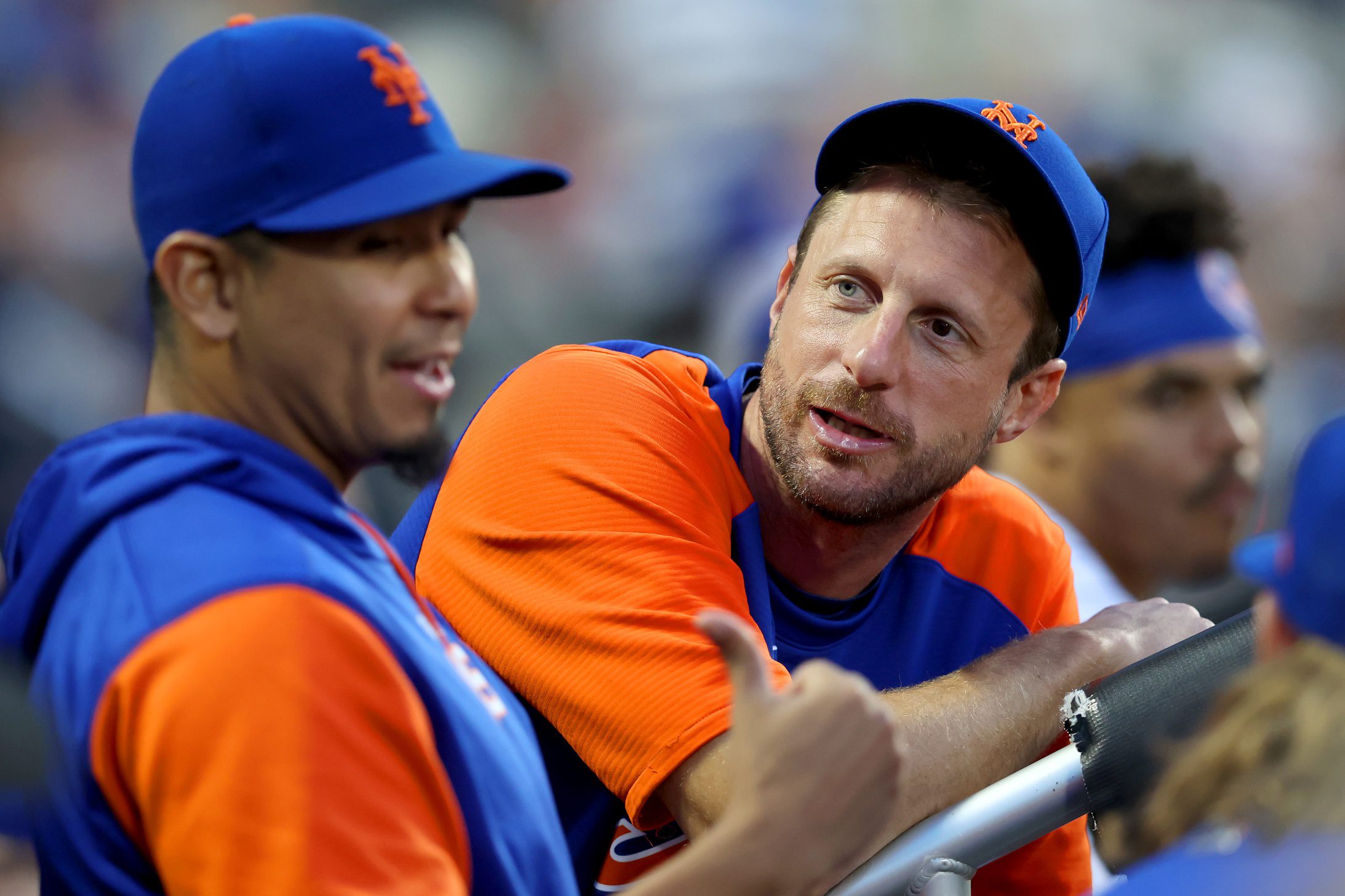 New York Mets injured pitcher Max Scherzer talks to starting pitcher Carlos Carrasco