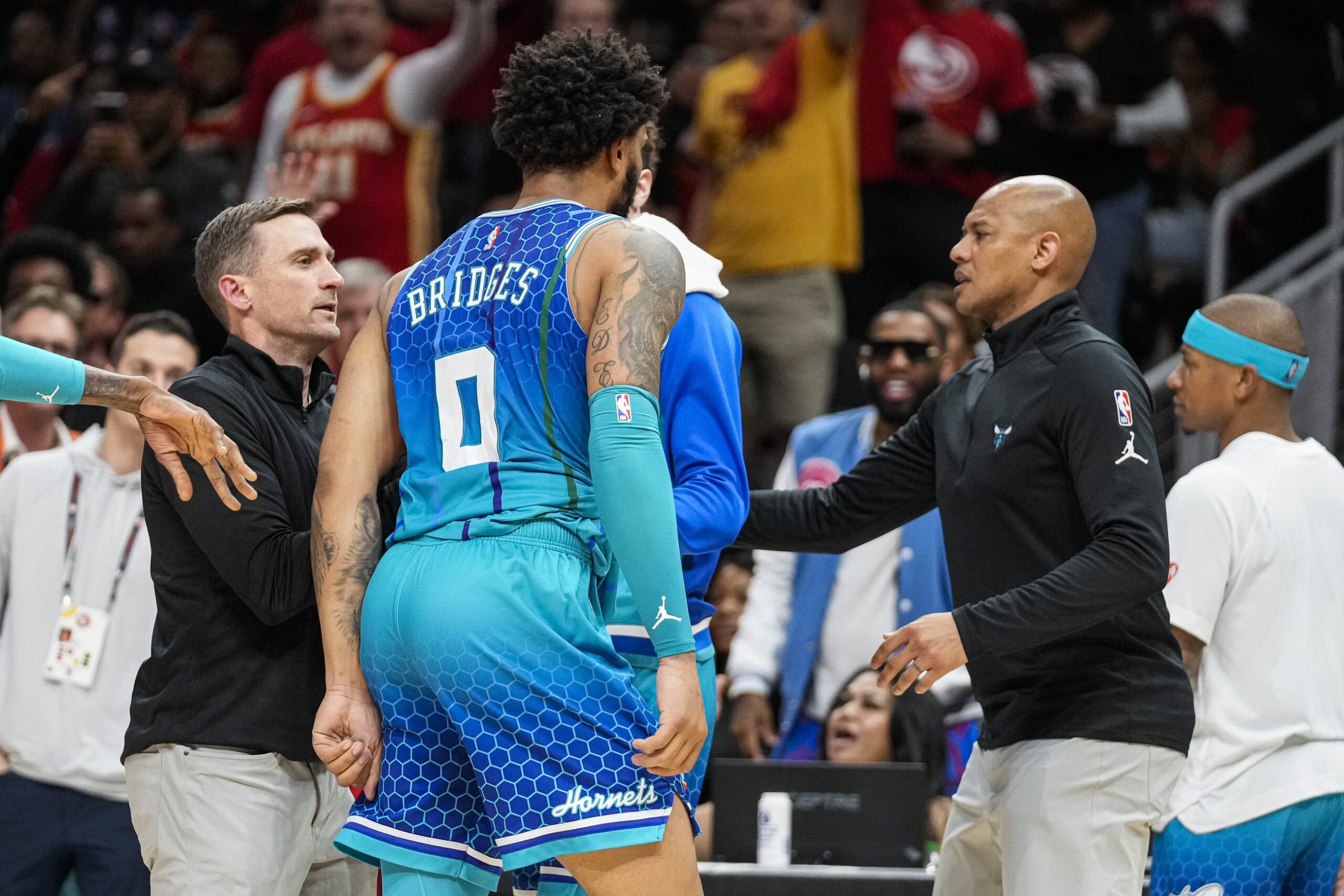 Charlotte Hornets forward Miles Bridges is restrained after being called for a technical foul