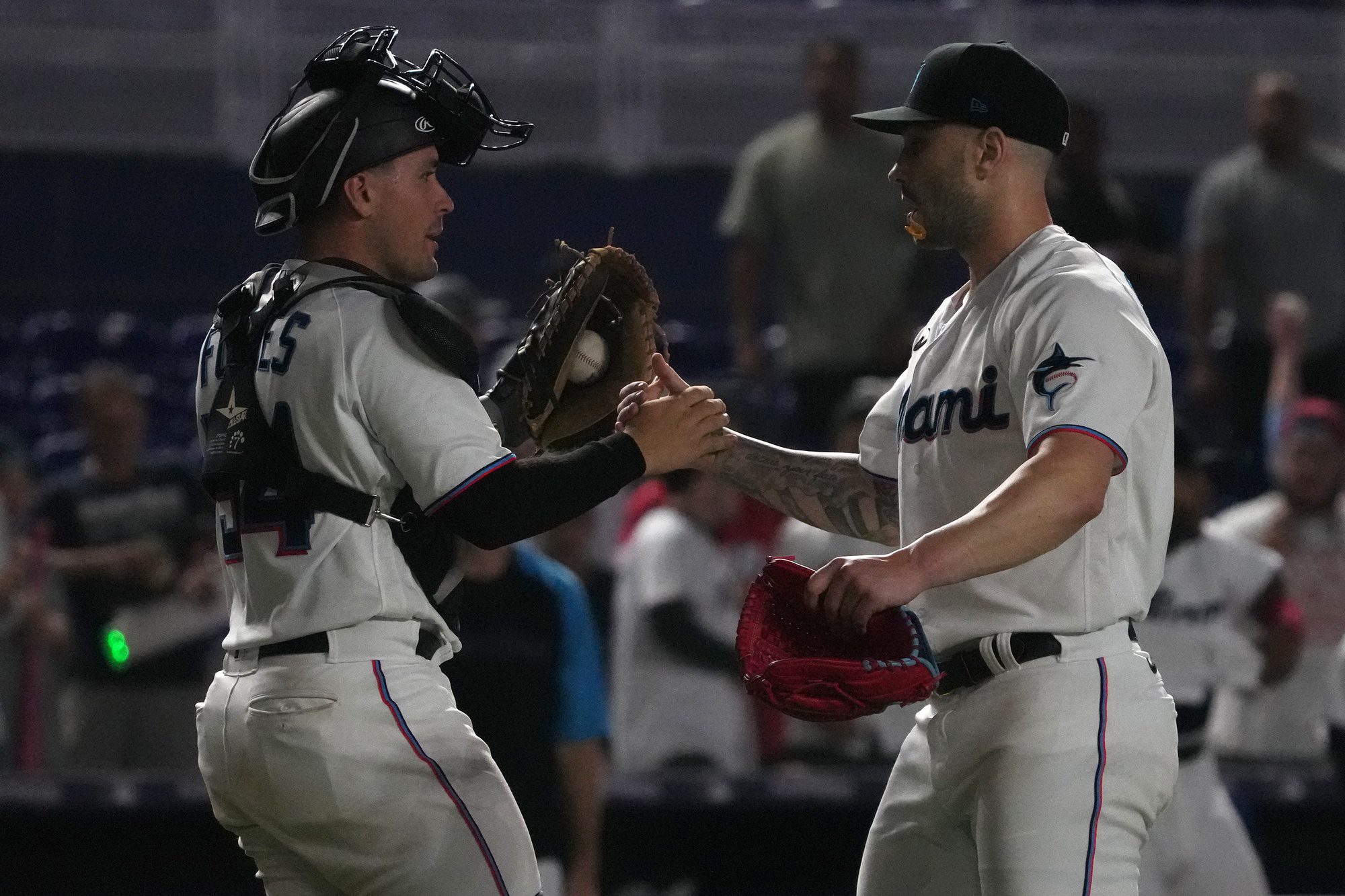 Miami Marlins catcher Nick Fortes celebrates with relief pitcher Tanner Scott